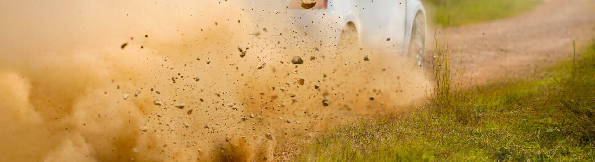 Gravel Splashing From Rally Car Drift On Dirt Track